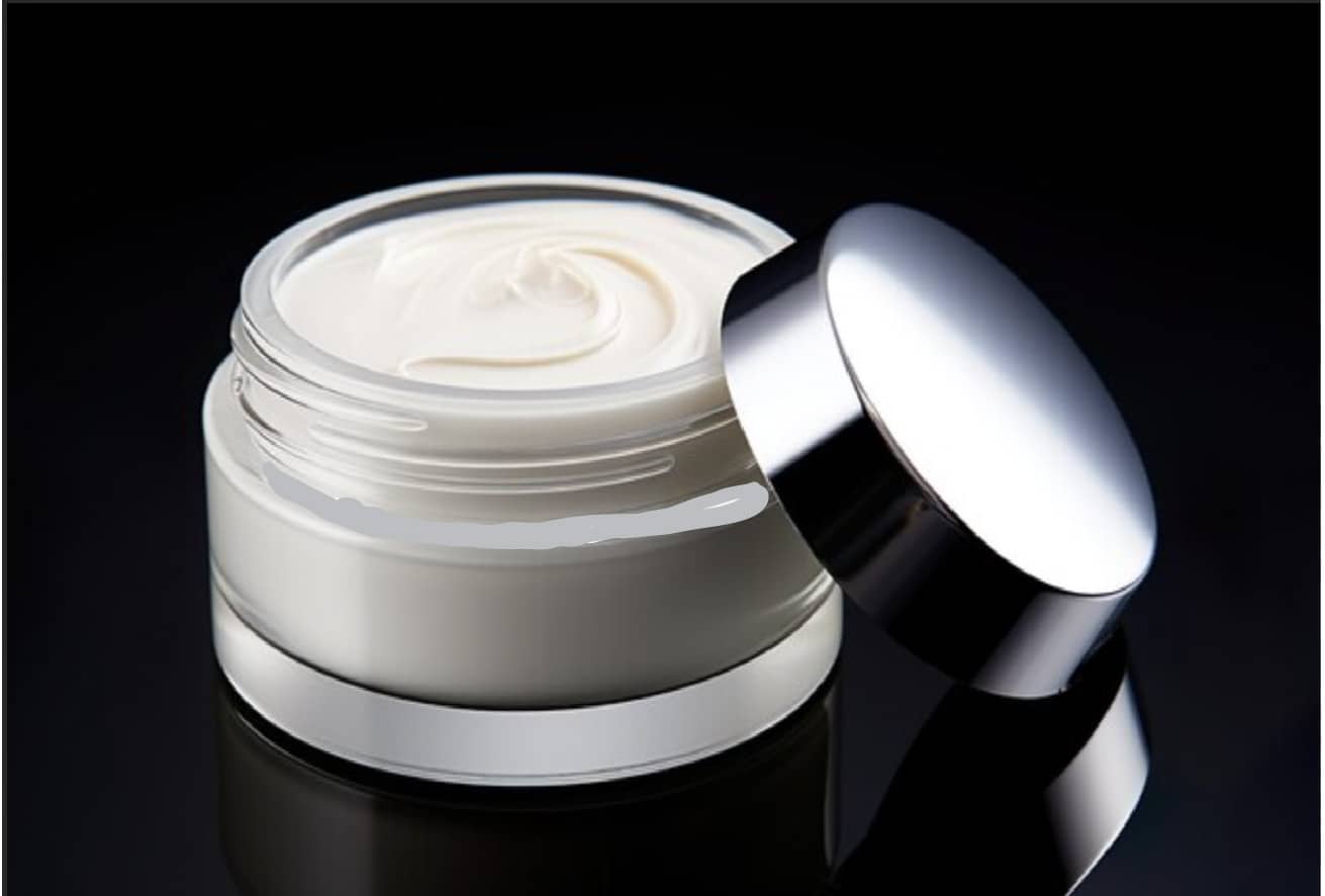 Cream jar with silver lid on a black background